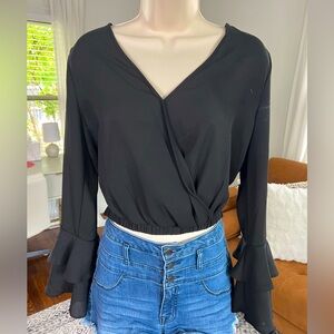 Size medium black crop top with ruffled design at wrists and v-neck overlay